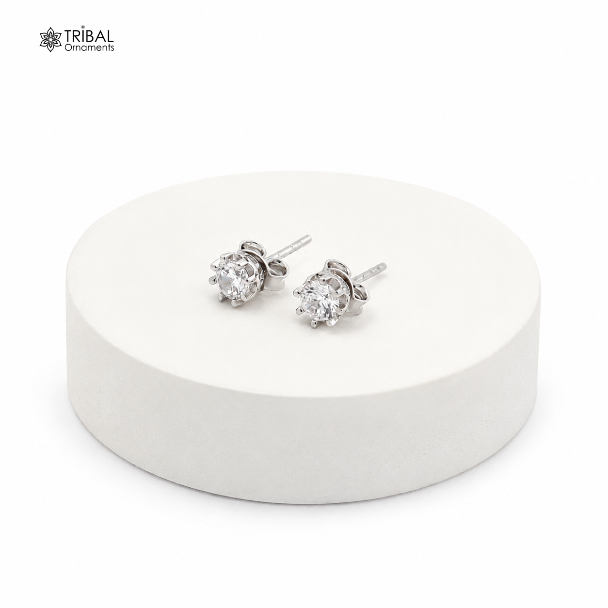 Sterling silver round white diamond stud earring by TRIBAL ORNAMENTS, unisex jewelry with sparkling gemstone detail.