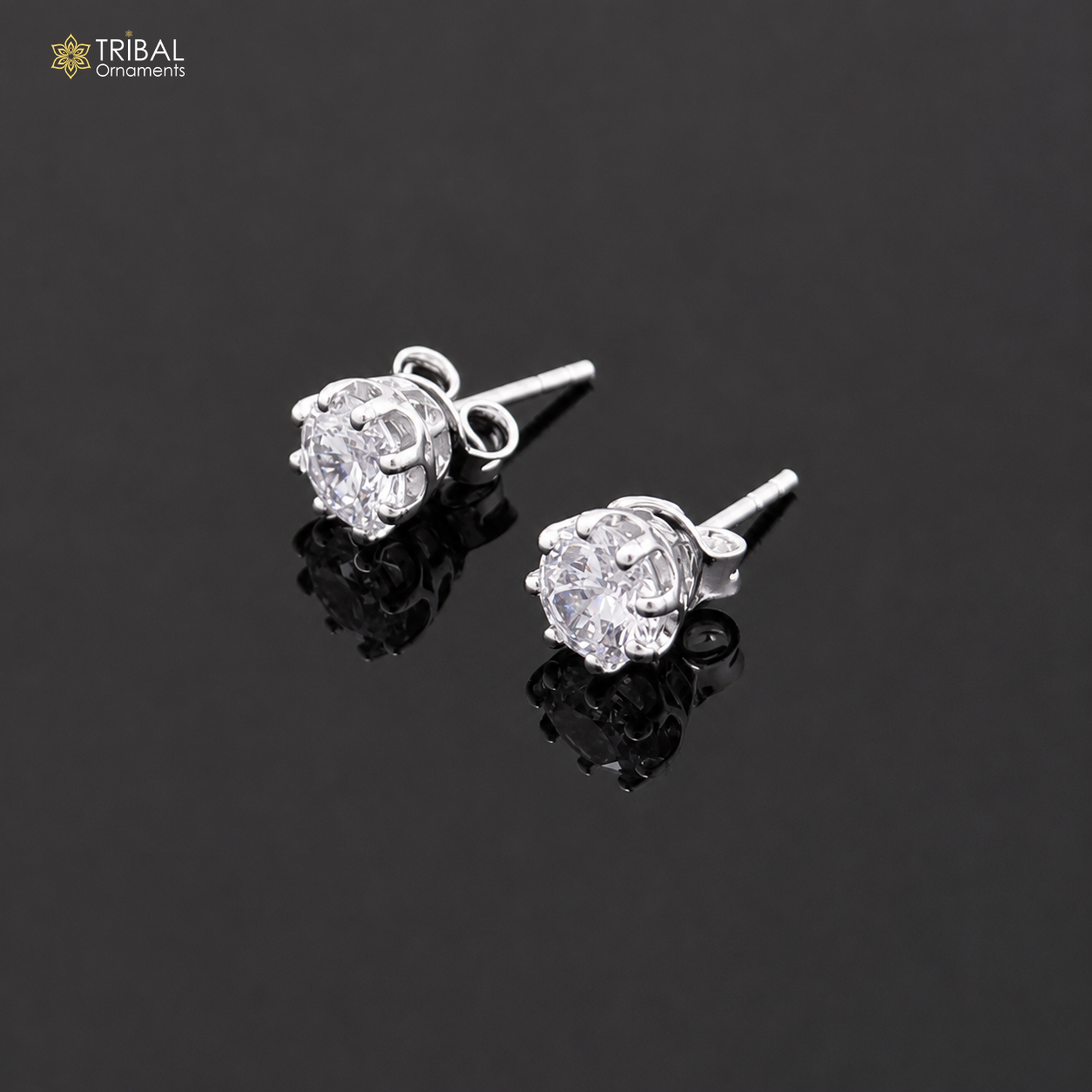Sterling silver white diamond stud earring with round shape, unisex jewelry, by TRIBAL ORNAMENTS, shown in close-up.