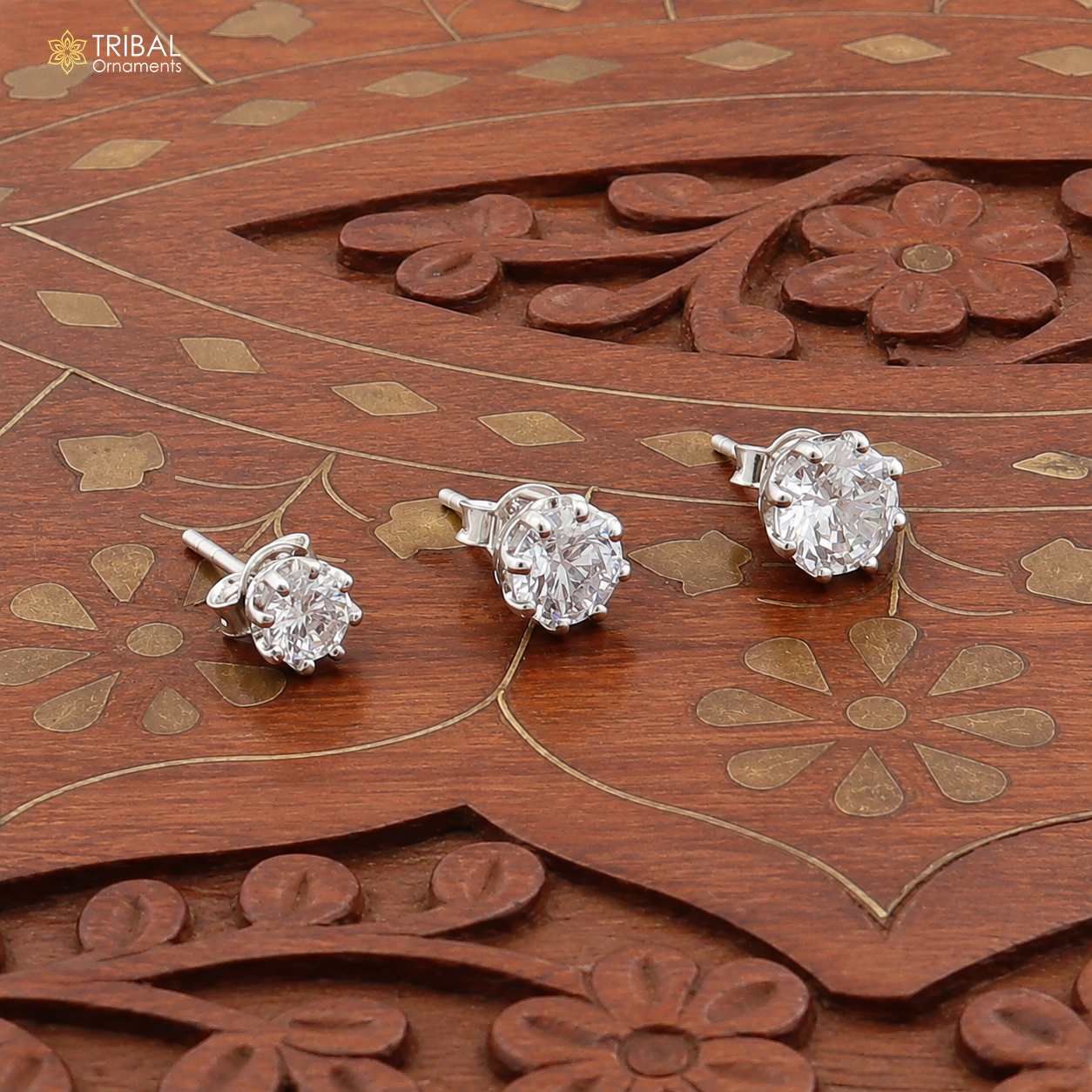 Sterling silver round white diamond stud earring by TRIBAL ORNAMENTS, unisex jewelry with a polished finish and sparkling gemstone.
