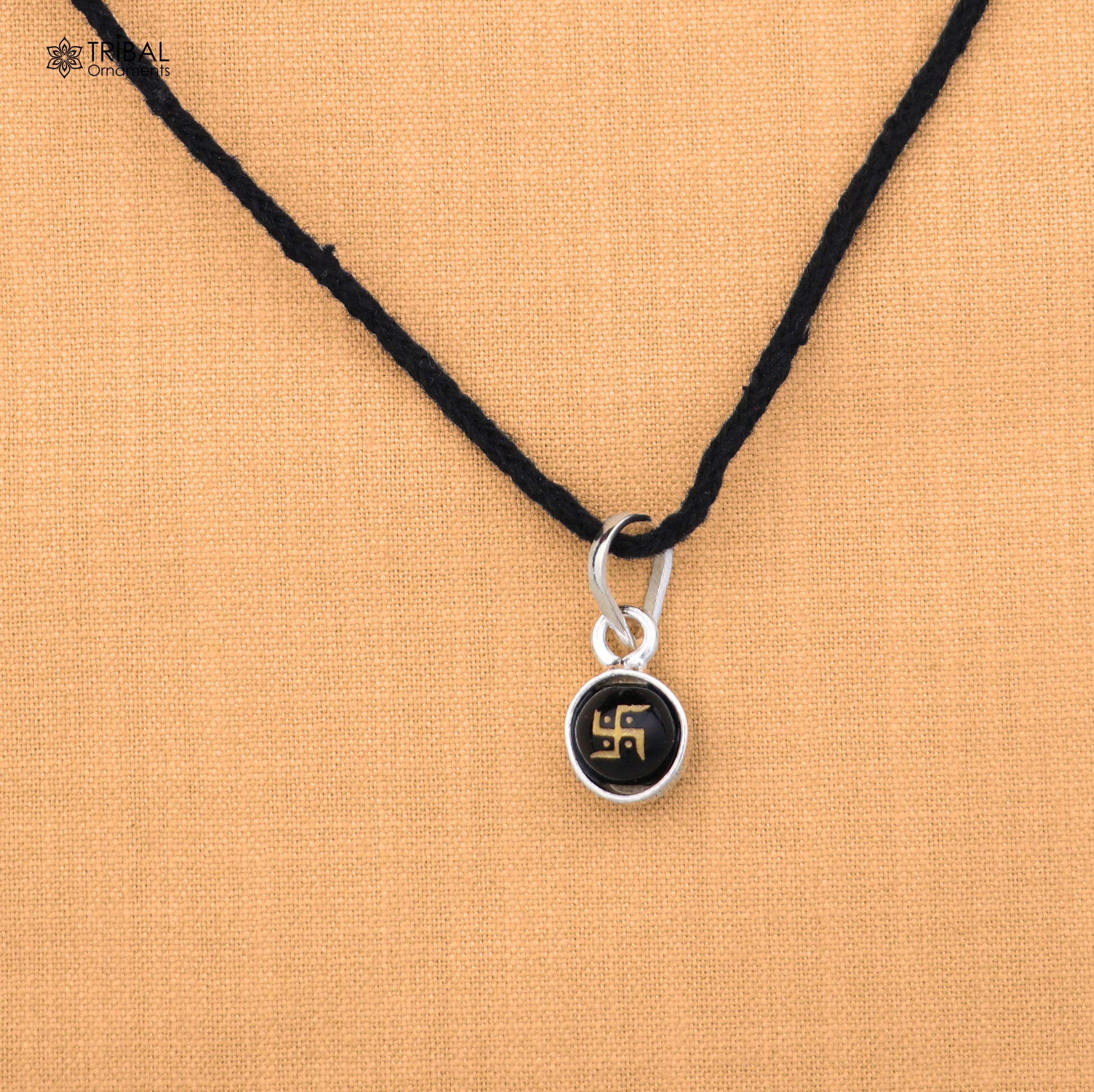 Sterling silver Swastik pendant for girls or kids jewelry, crafted by TRIBAL ORNAMENTS, with intricate design and polished finish.