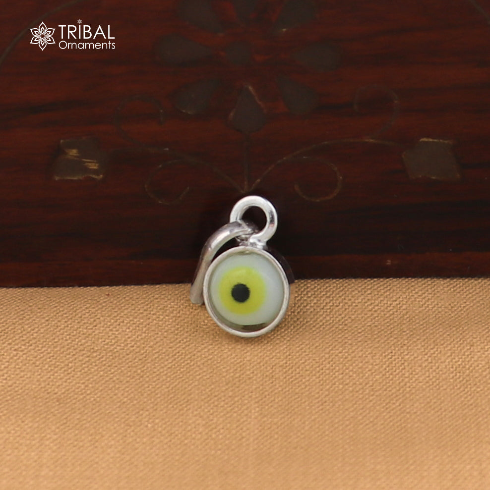 Sterling silver evil eye pendant for girls and kids, protective jewelry by TRIBAL ORNAMENTS, featuring a detailed evil eye design.