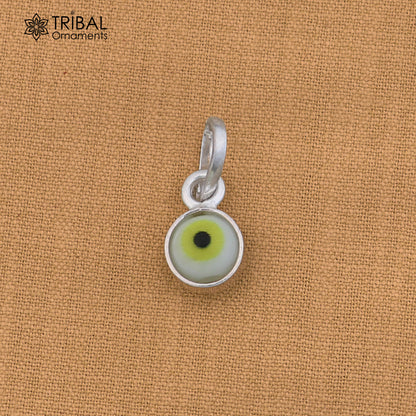 Sterling silver evil eye pendant for girls and kids, protective jewelry by TRIBAL ORNAMENTS, shown in close-up on a white background.