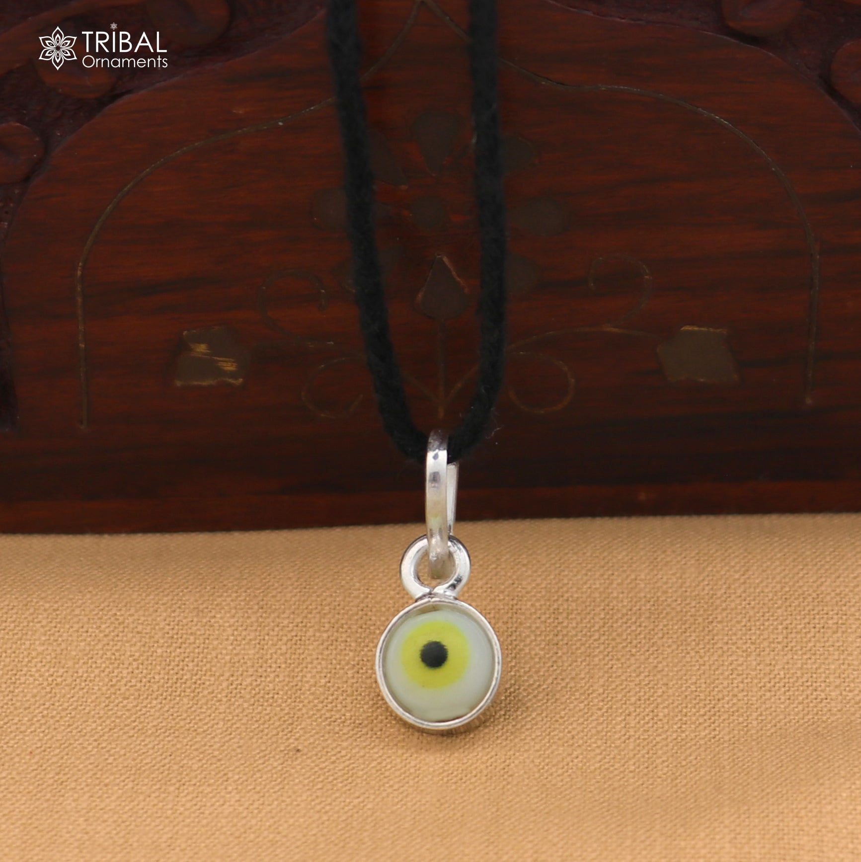 Sterling silver evil eye pendant for girls and kids, protective jewelry by TRIBAL ORNAMENTS, featuring a blue and silver design.