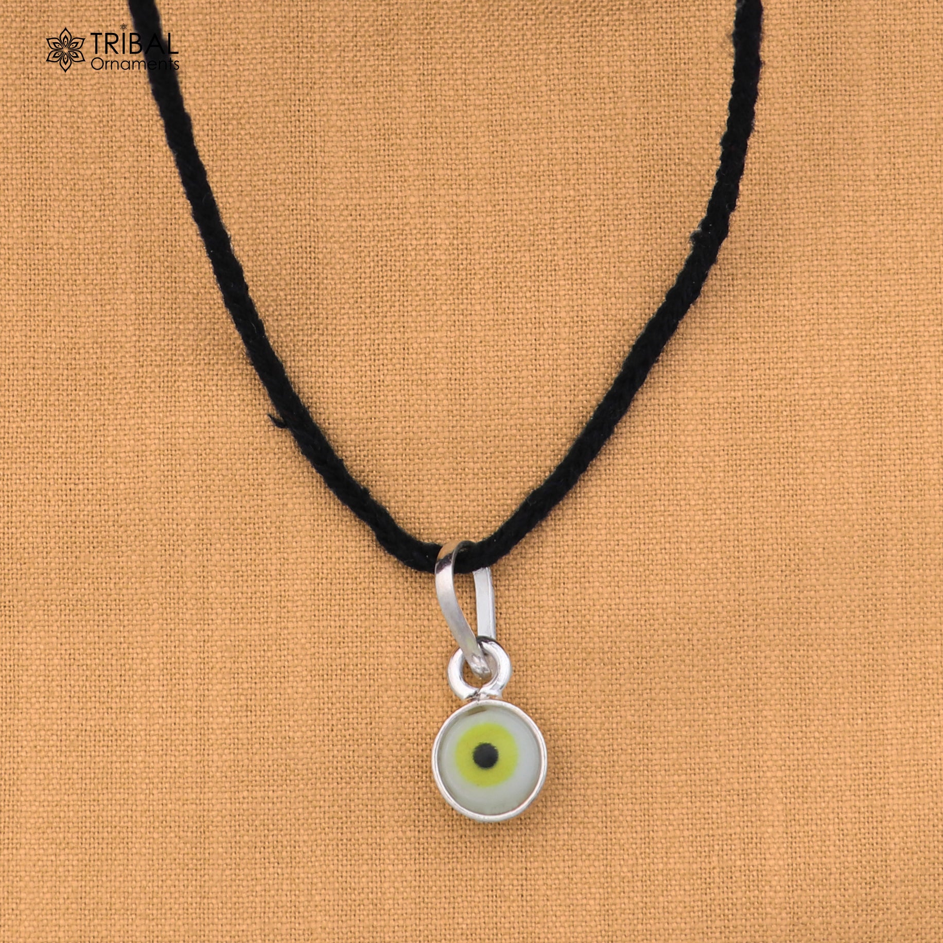 Sterling silver evil eye pendant for girls and kids, protective jewelry by TRIBAL ORNAMENTS, featuring a blue eye design.