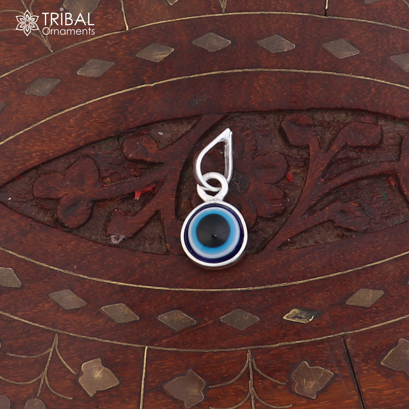 Sterling silver evil eye pendant for girls and kids, unisex protection jewelry by Tribal Ornaments, shown in detailed close-up.