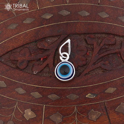 Sterling silver evil eye pendant for girls and kids, unisex protection jewelry by Tribal Ornaments, shown in detailed close-up.