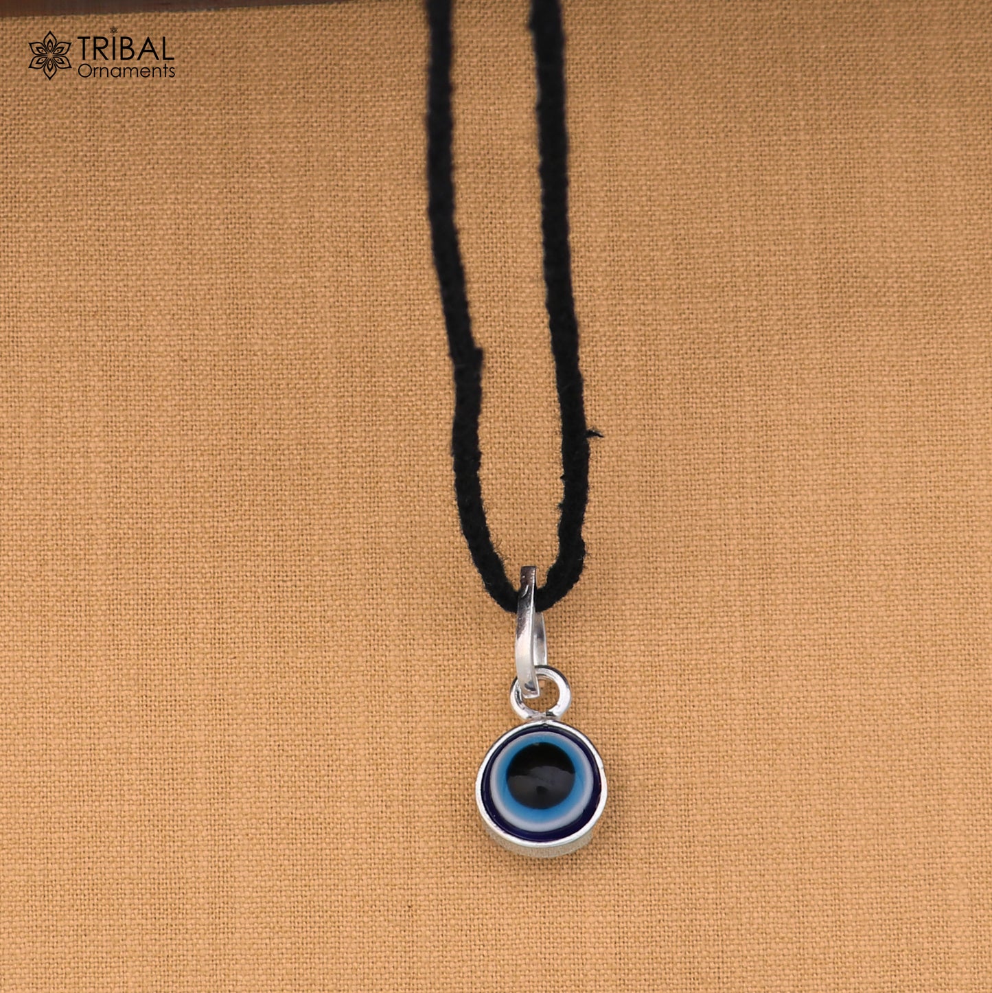 Sterling silver evil eye pendant for girls and kids, protective jewelry by TRIBAL ORNAMENTS, featuring a detailed eye design.