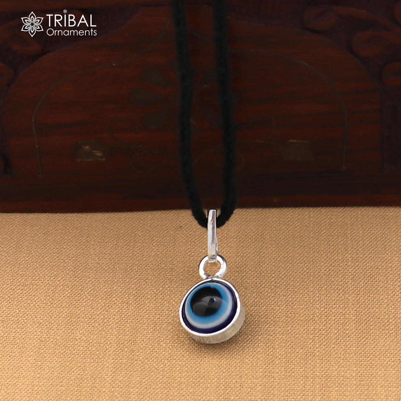 Sterling silver evil eye pendant for girls and kids, tribal jewelry for protection, featuring a blue eye design.