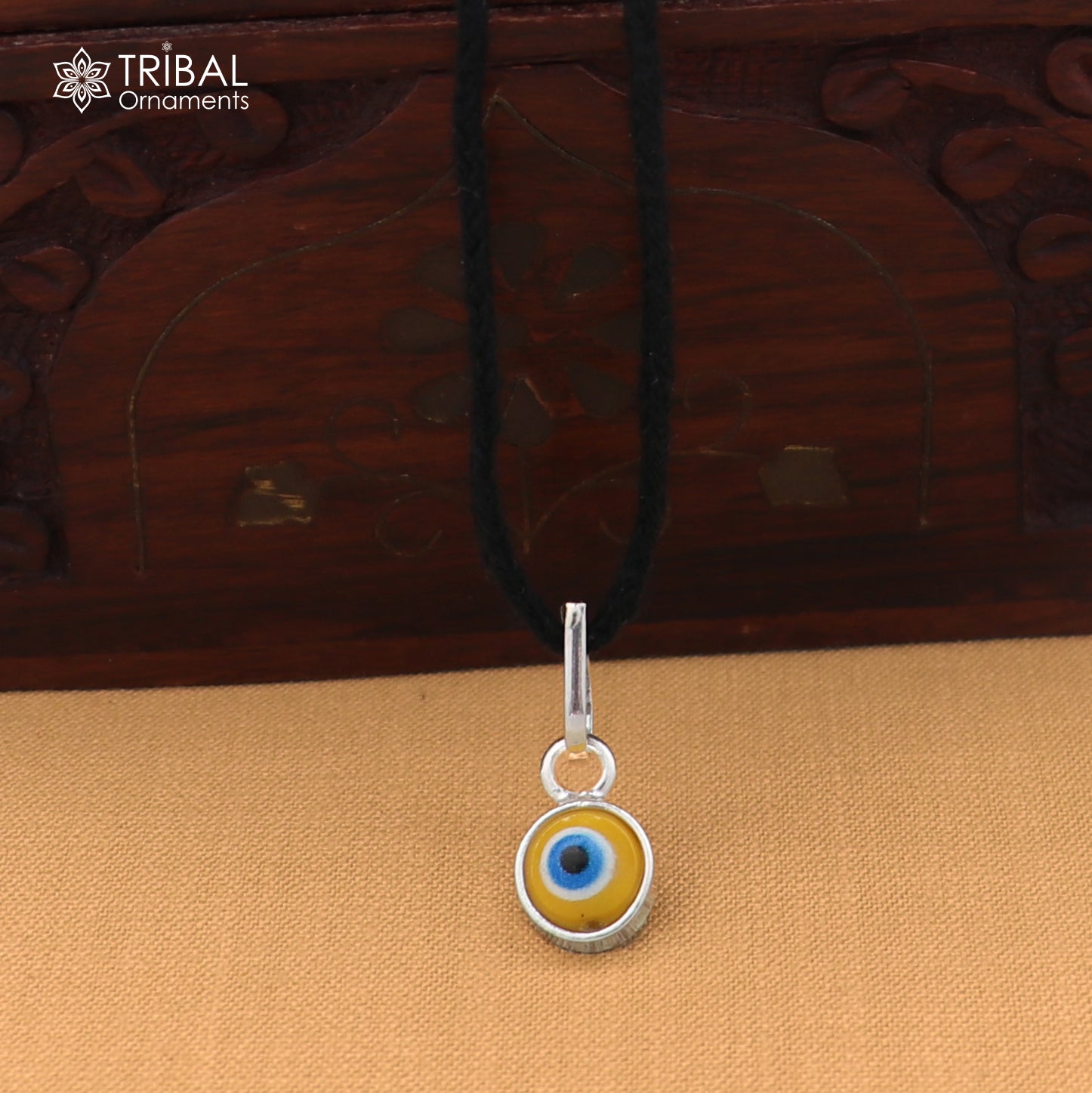 925 sterling silver evil eye pendant for girls or kids, protective jewelry by TRIBAL ORNAMENTS, featuring a detailed evil eye design.