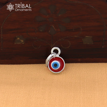 Sterling silver evil eye pendant for girls and kids, protective jewelry by TRIBAL ORNAMENTS, featuring a blue and silver design.