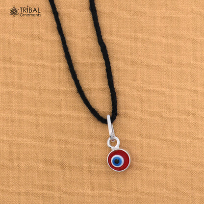 Sterling silver evil eye pendant for kids, protective jewelry by TRIBAL ORNAMENTS, featuring a detailed evil eye design.