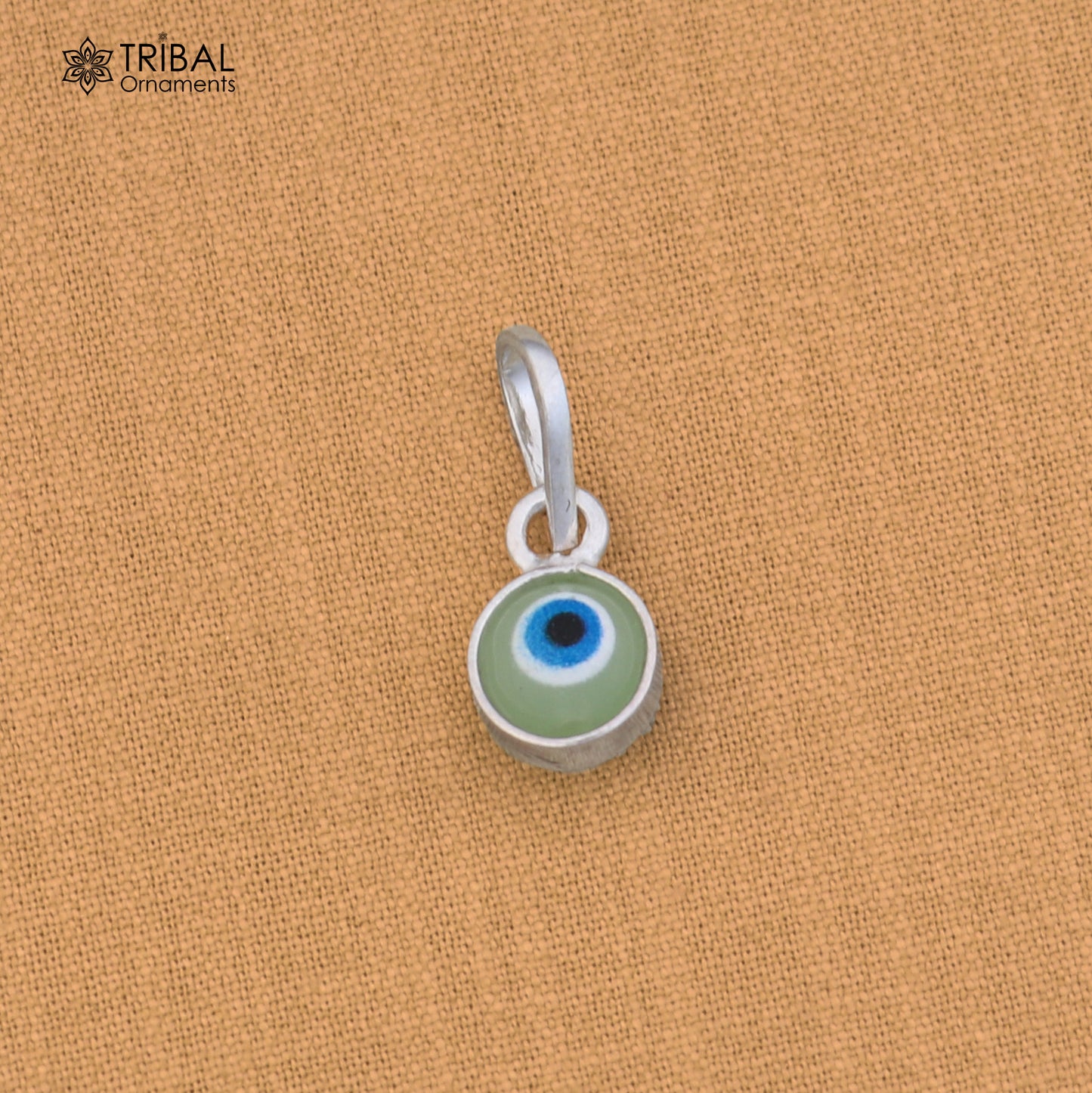 Sterling silver evil eye pendant for girls, protective jewelry by TRIBAL ORNAMENTS, featuring a blue eye design with silver setting.
