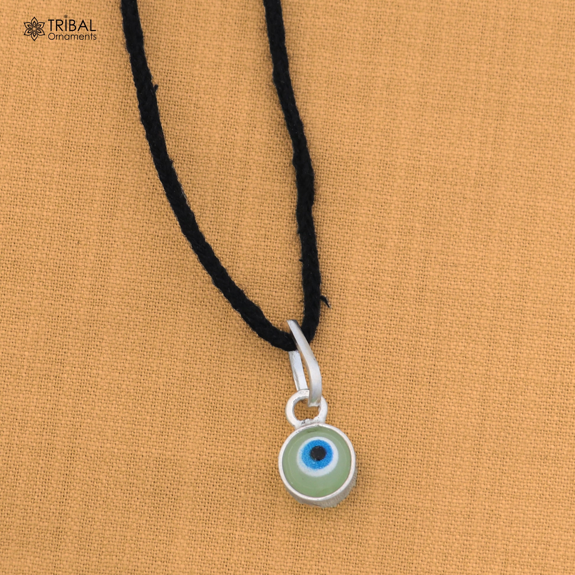 Sterling silver evil eye pendant for girls, featuring a protective design, by TRIBAL ORNAMENTS.