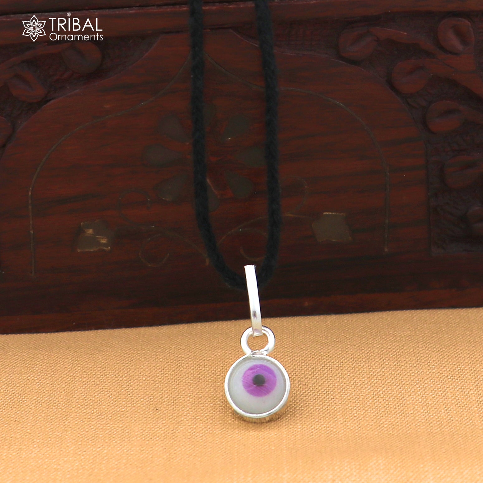 Sterling silver evil eye pendant for girls and kids, tribal ornament jewelry for protection, detailed design in the image.