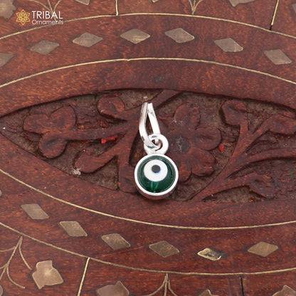 Sterling silver evil eye pendant for girls or kids, protective jewelry by TRIBAL ORNAMENTS, featuring a blue and silver design.