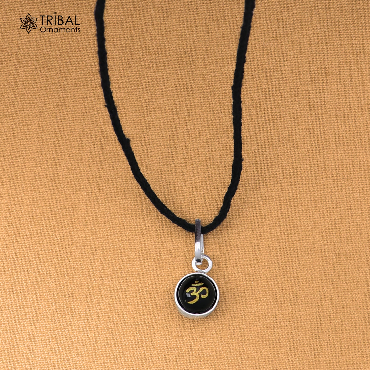 Sterling silver om design pendant for girls and kids, protective jewelry by TRIBAL ORNAMENTS, featuring a detailed om symbol.