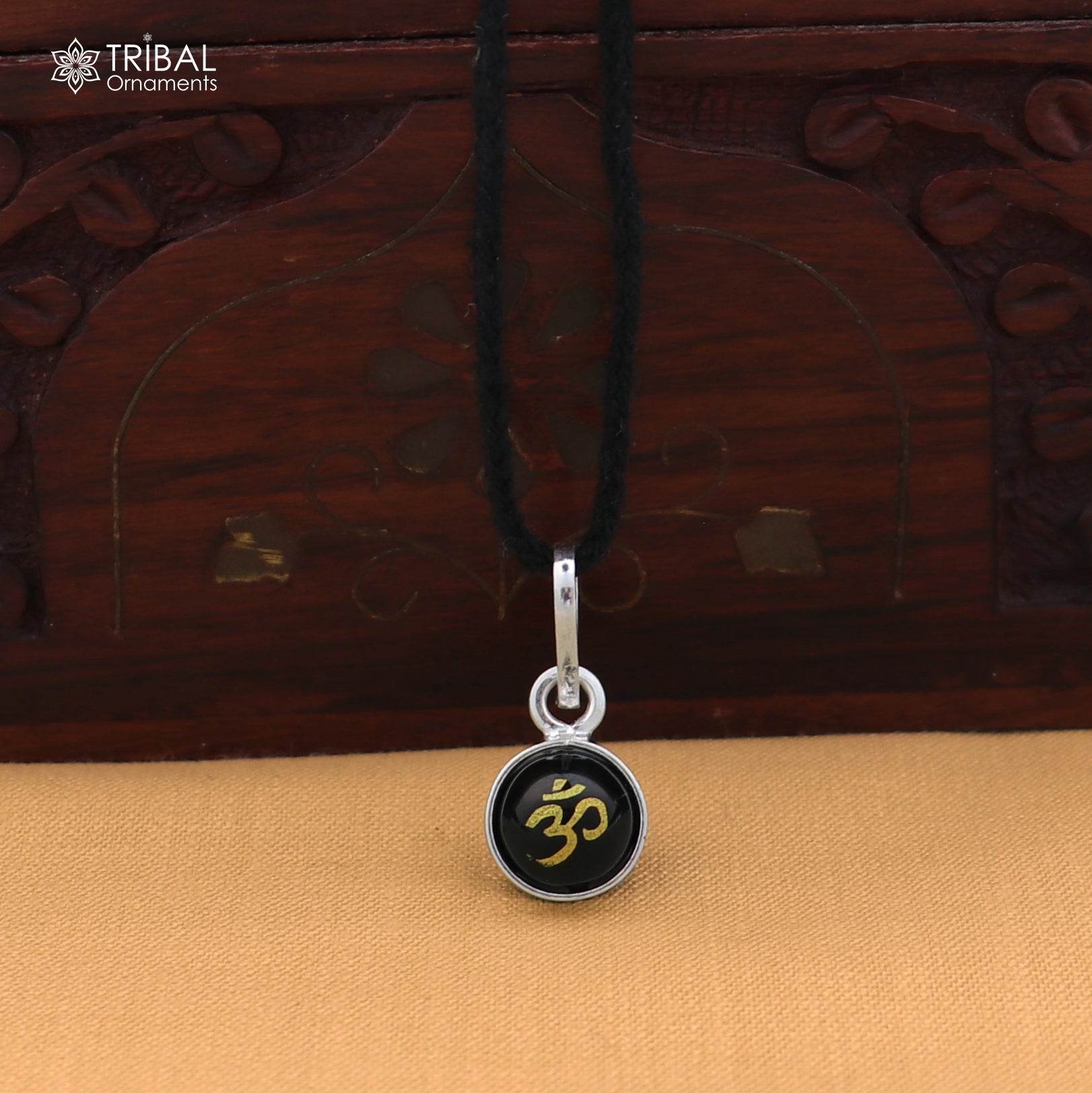 Sterling silver OM pendant for girls or kids, protective jewelry by TRIBAL ORNAMENTS, featuring a detailed Om design.