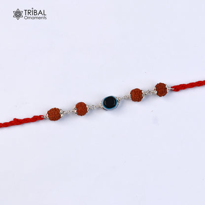 Sterling silver RUDRAKSHA and evil eye beads on red thread rakhi bracelet with intricate designs from TRIBAL ORNAMENTS.