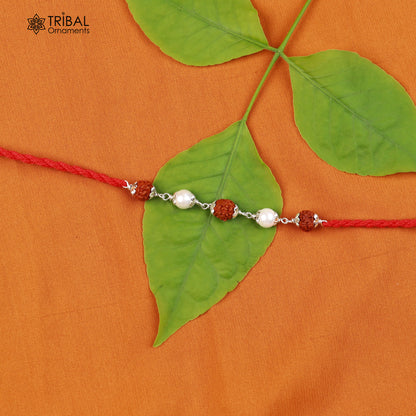Sterling silver RUDRAKSHA and pearl beads Rakhi bracelet with red thread, crafted by TRIBAL ORNAMENTS for traditional celebrations.