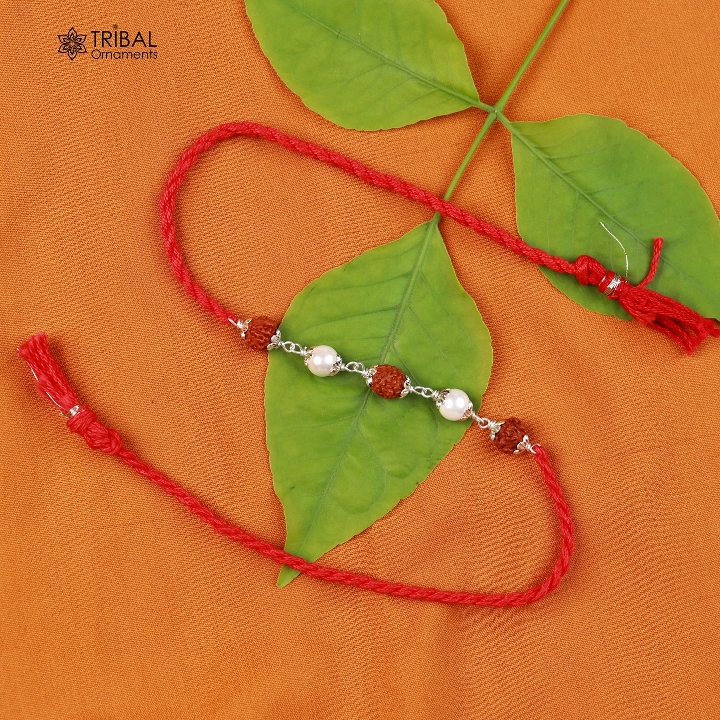 Sterling silver RUDRAKSHA and pearl beads Rakhi bracelet on red thread, crafted by TRIBAL ORNAMENTS.