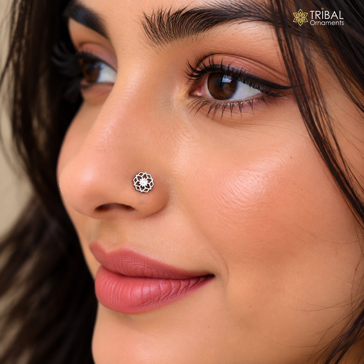 Sterling silver vintage star-style nose pin with jeweled accents, tribal ethnic jewelry, close-up portrait showing intricate design.