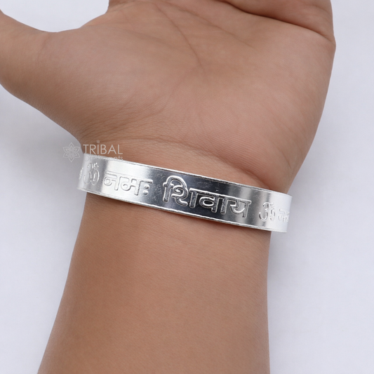 Sterling silver "Aum Namah Shivay" mantra cuff bracelet by Tribal Ornaments, featuring engraved script on a sleek silver band.