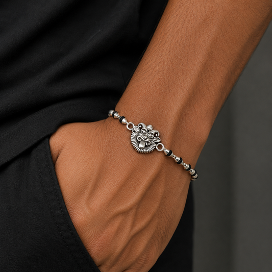 Sterling silver evil eye Nazar Battu bracelet with black Tulsi beads, traditional Rakhi design from TRIBAL ORNAMENTS.