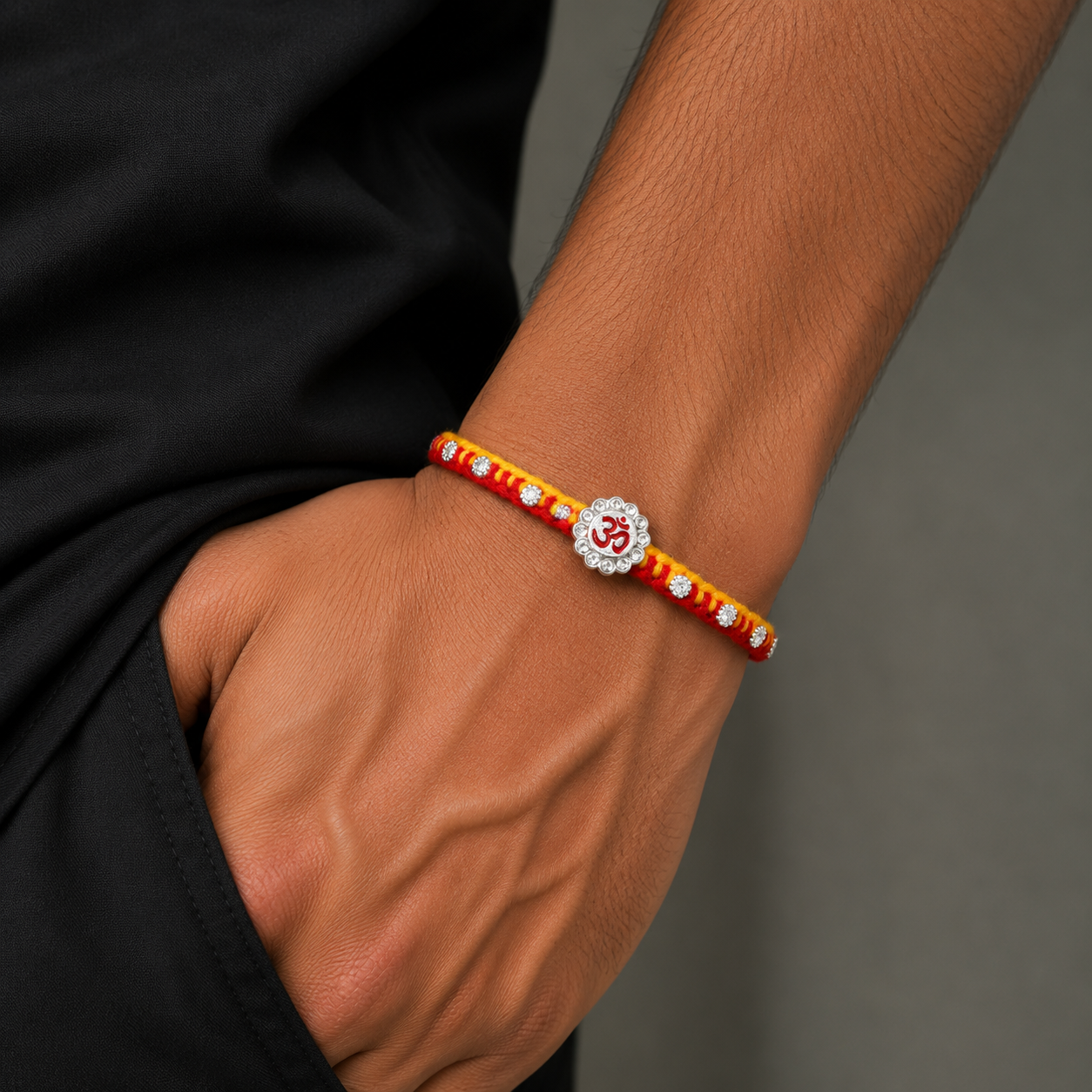 Sterling silver Om design thread rakhi bracelet with intricate detailing from TRIBAL ORNAMENTS, showcasing traditional craftsmanship.