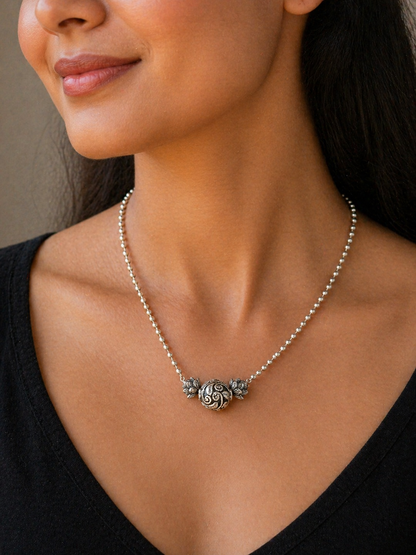 Sterling silver 4mm bead necklace with traditional tribal pendant, handmade jewelry with cultural design and unique ball accents.