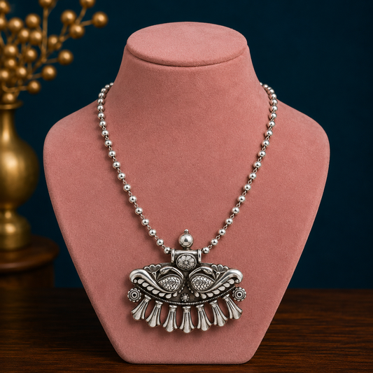Vintage tribal-style sterling silver pendant necklace with intricate cultural design and handmade craftsmanship from India.