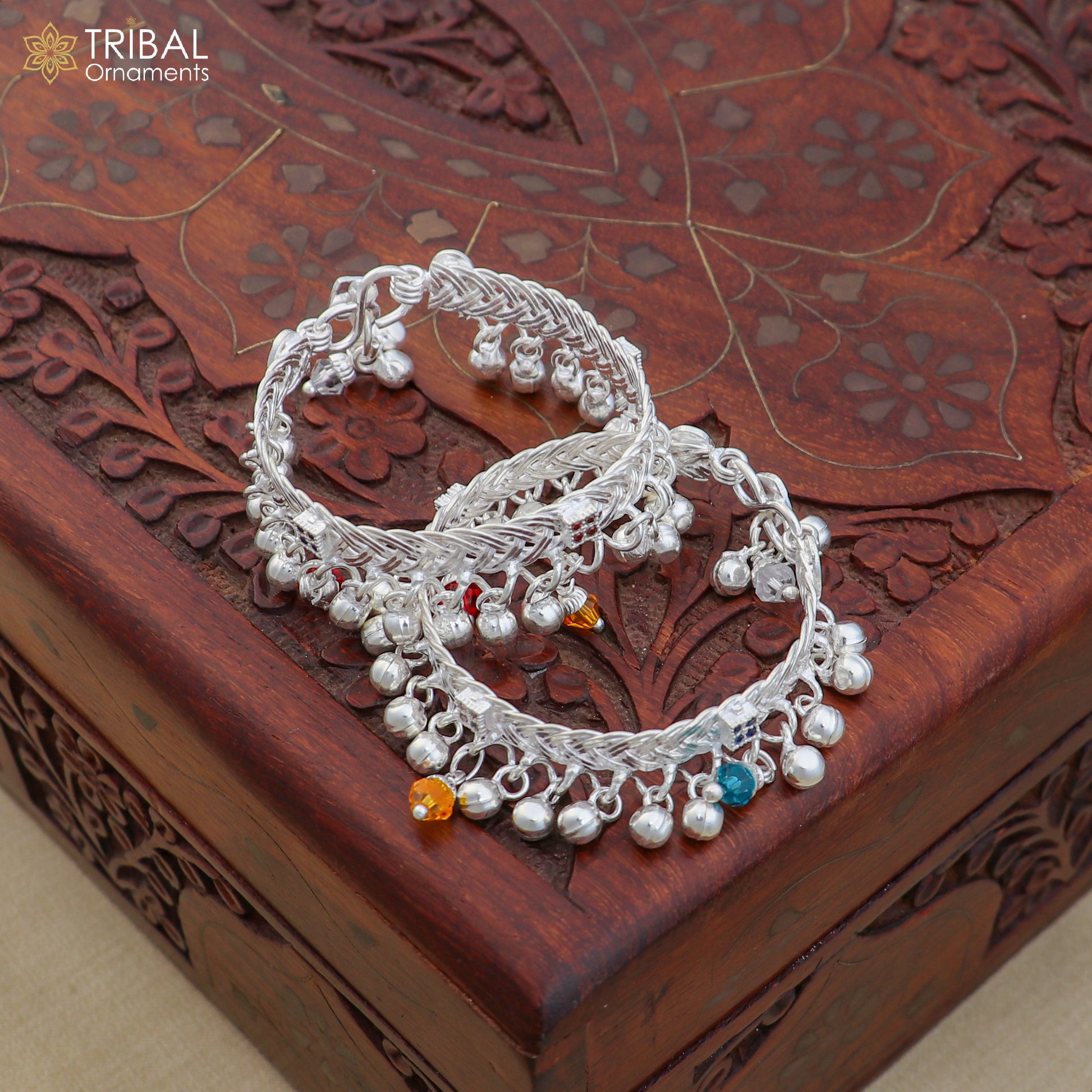 Sterling silver customized baby anklet with jingling charms, featuring delicate design and secure clasp from TRIBAL ORNAMENTS.