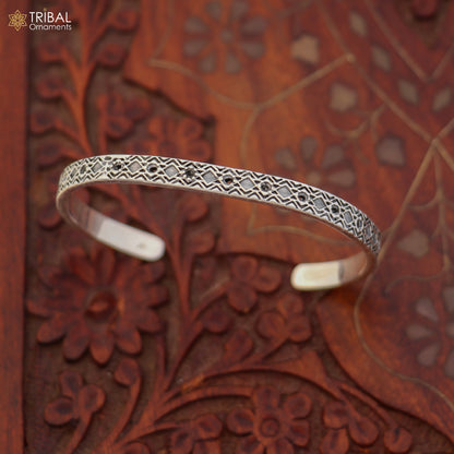 Sterling silver adjustable bangle cuff bracelet with stylish unisex design, featuring intricate tribal ornament details.