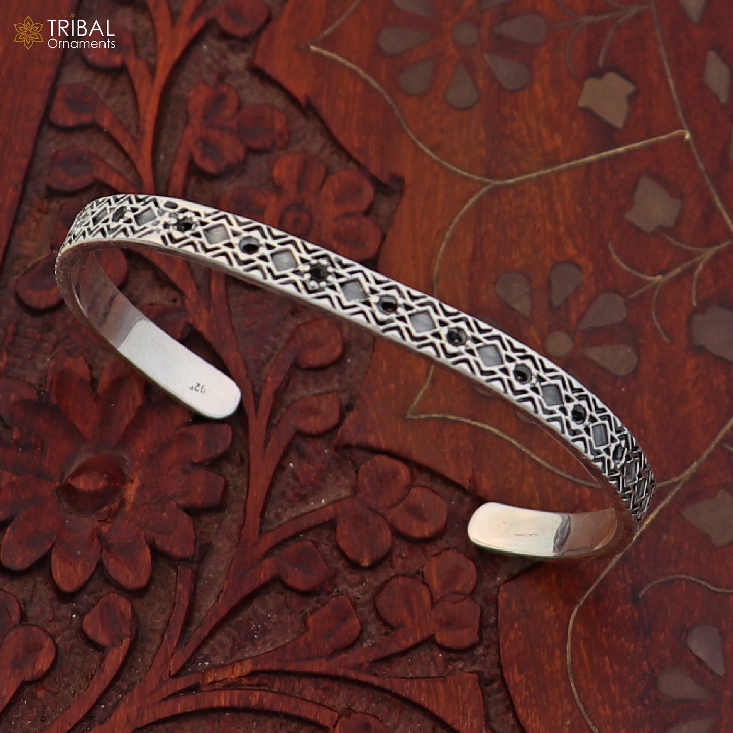 Sterling silver adjustable bangle bracelet with stylish unisex cuff design, featuring intricate tribal ornament details.