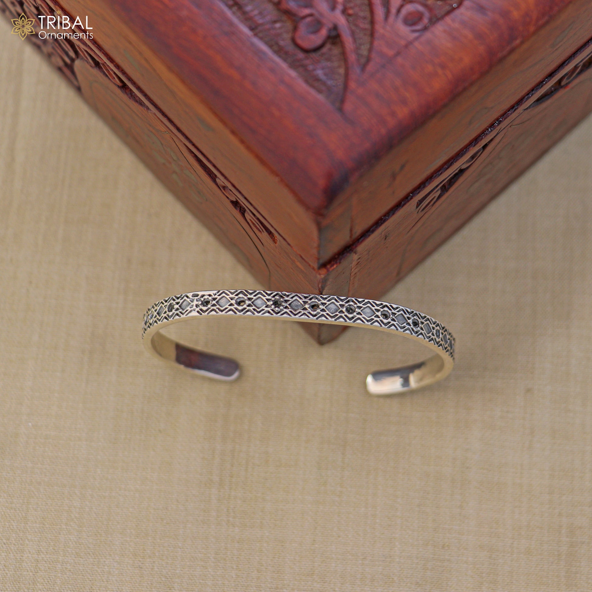 Sterling silver adjustable bangle bracelet by TRIBAL ORNAMENTS, stylish unisex jewelry cuff with intricate design.