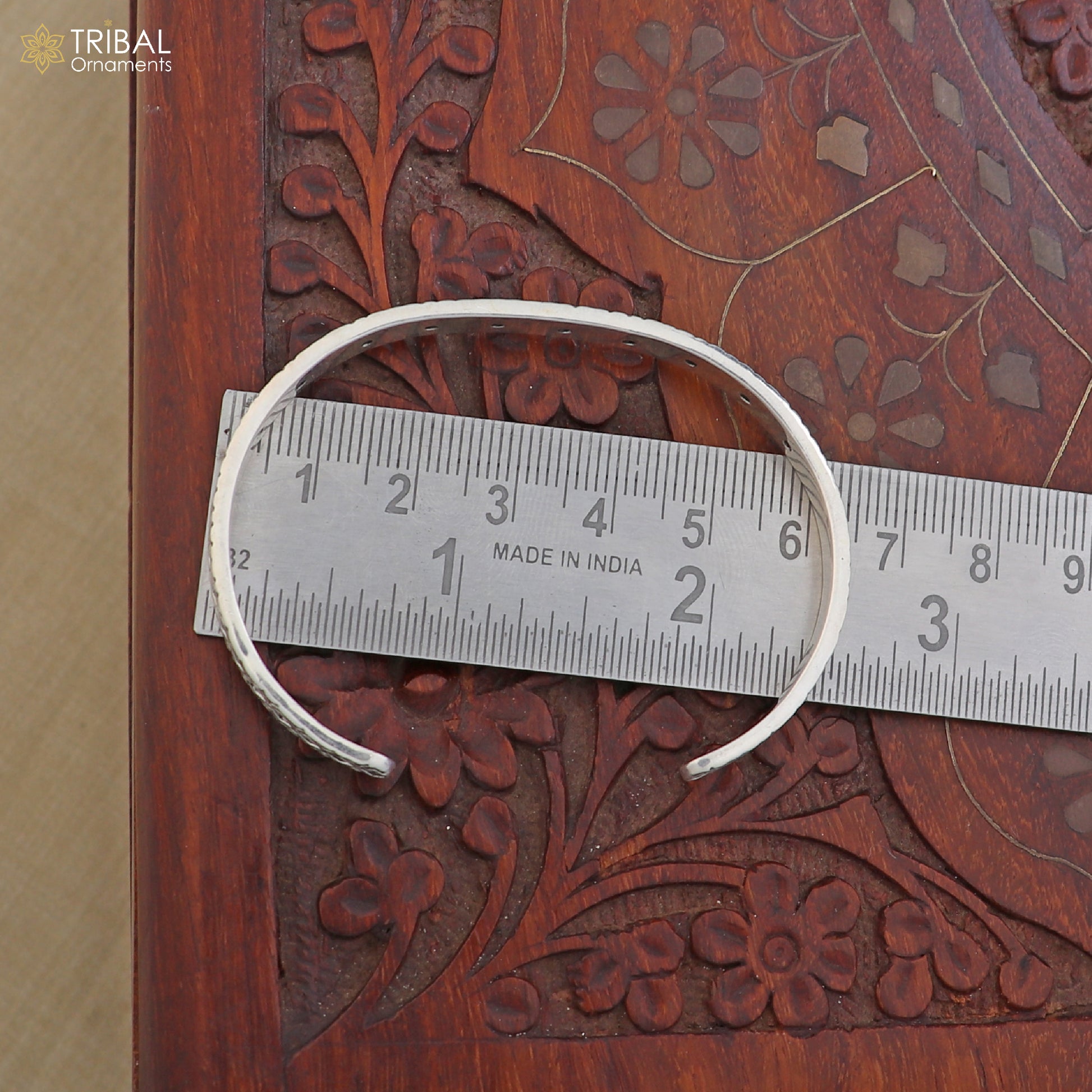 Sterling silver adjustable bangle bracelet by Tribal Ornaments, stylish unisex jewelry cuff with intricate design.