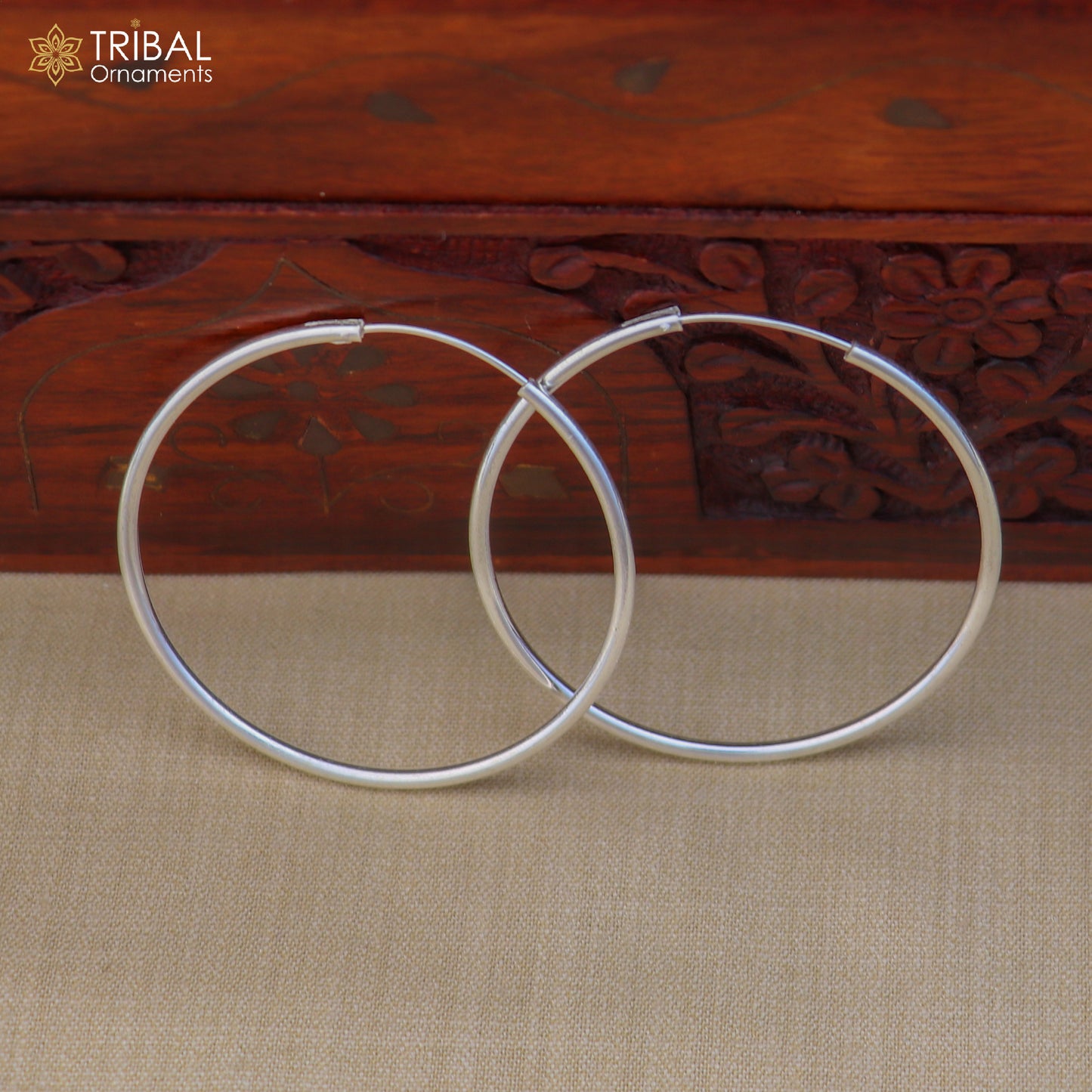 Elegant 925 sterling silver round hoops earrings by TRIBAL ORNAMENTS, showcasing smooth polished surface and classic hoop design.