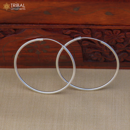 Elegant 925 sterling silver round hoop earrings by TRIBAL ORNAMENTS, showcasing smooth polished surface and classic jewelry style.