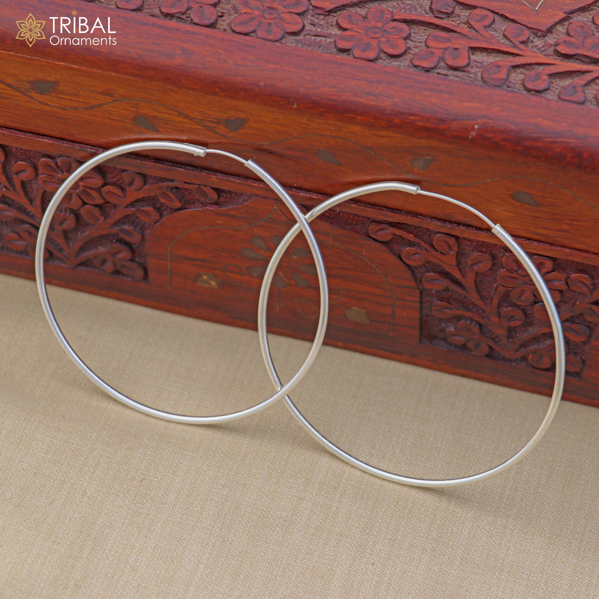 Elegant 925 sterling silver round hoops earrings by TRIBAL ORNAMENTS, showcasing smooth, polished surface and classic hoop design.