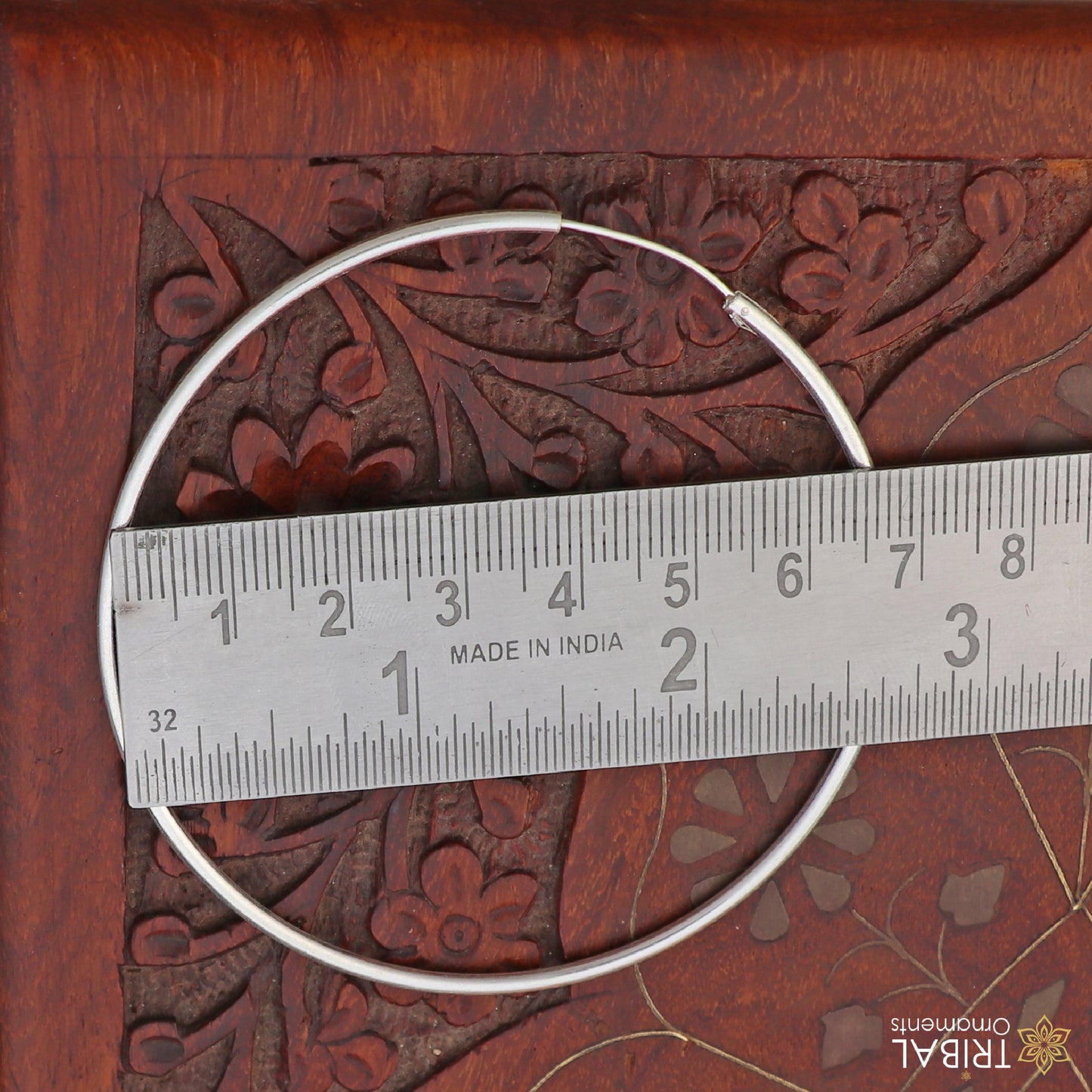 Elegant 925 sterling silver round hoops earrings by TRIBAL ORNAMENTS, showcasing smooth polished surface and classic hoop design.