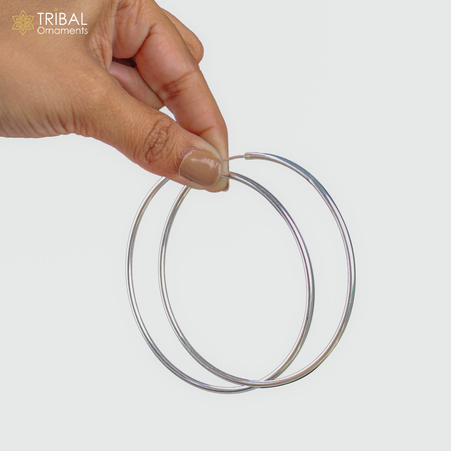 Elegant 925 sterling silver round hoop earrings by TRIBAL ORNAMENTS, showcasing smooth polished finish and classic jewelry design.