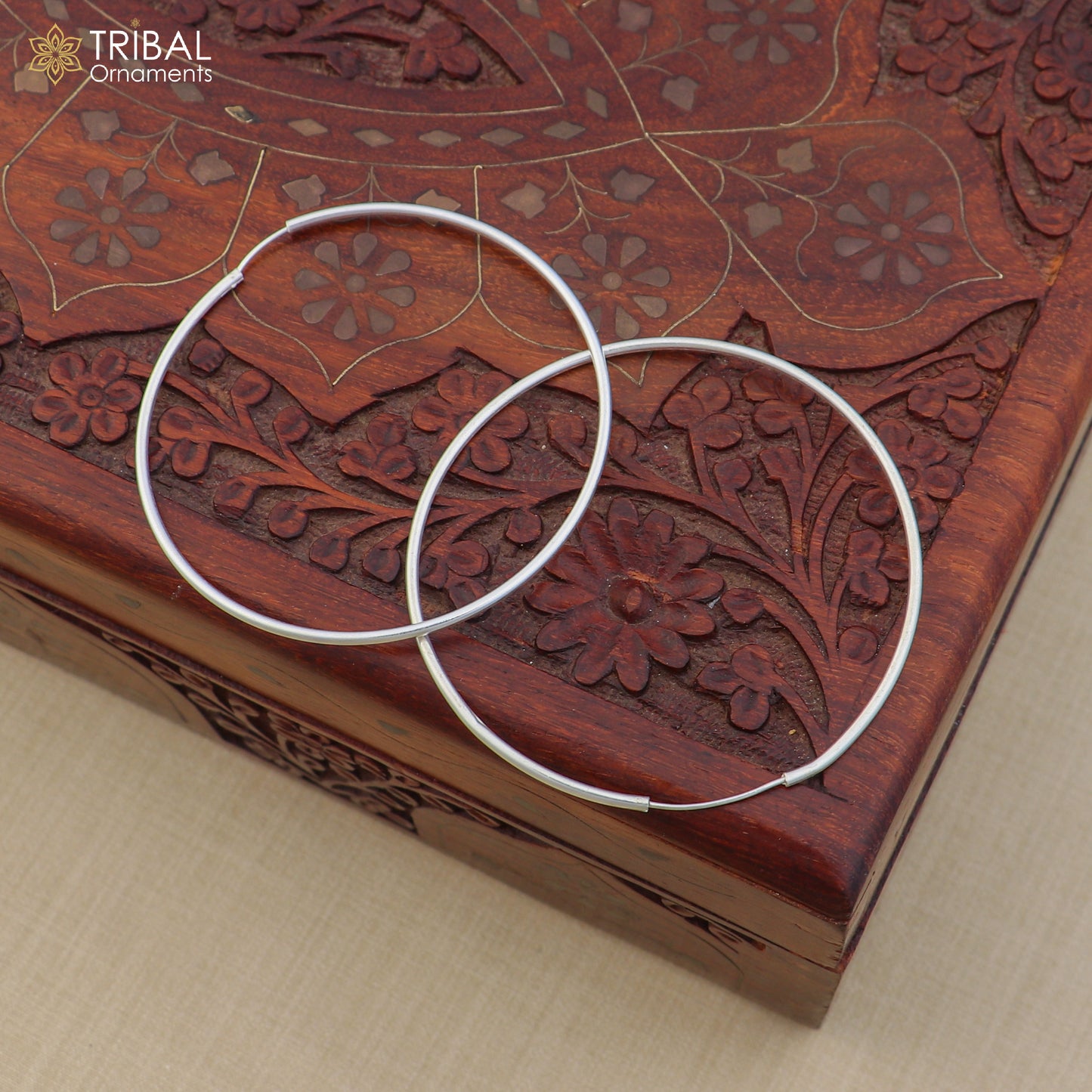 Elegant 925 sterling silver round hoops earrings by TRIBAL ORNAMENTS, showcasing smooth, polished jewelry design.