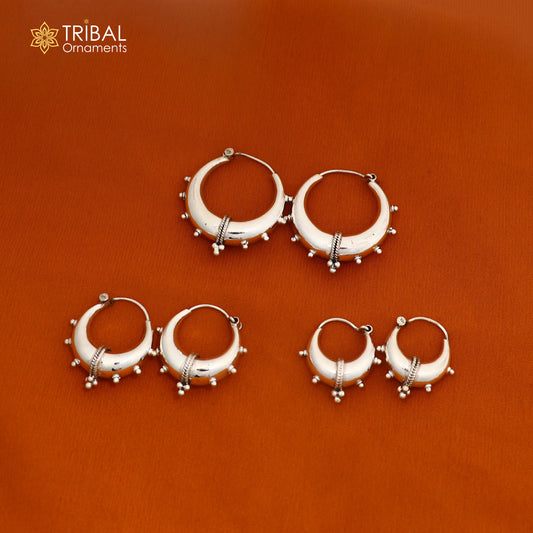 Sterling silver stylish shiny hoop earrings by TRIBAL ORNAMENTS, unisex jewelry with a sleek polished finish.