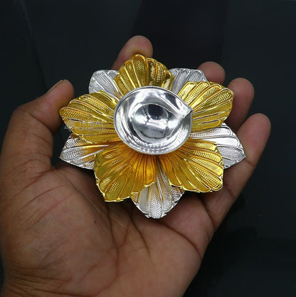 Silver flower design oil lamp by TRIBAL ORNAMENTS, 925 pure silver home temple deepak with intricate floral detailing.