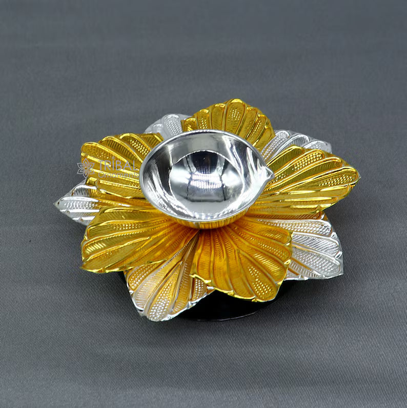 Pure silver flower design oil lamp by TRIBAL ORNAMENTS, decorative deepak for home temple, detailed floral craftsmanship.