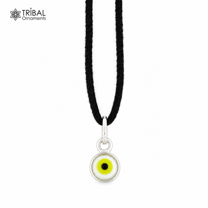 Sterling silver evil eye pendant for girls and kids, protective jewelry by TRIBAL ORNAMENTS, featuring a blue and white eye design.