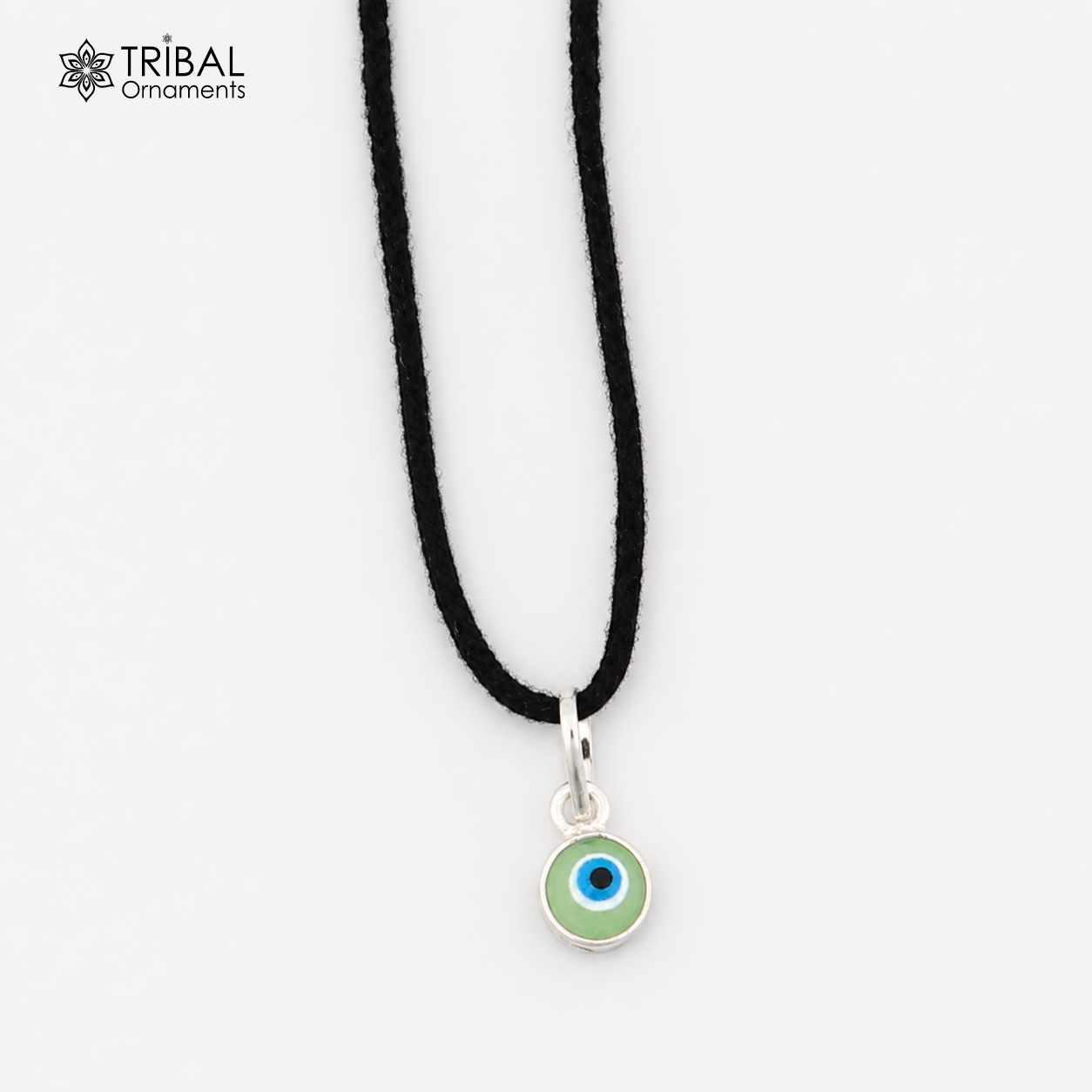 Sterling silver evil eye pendant for girls and kids, protective jewelry by TRIBAL ORNAMENTS, featuring a blue and silver eye design.