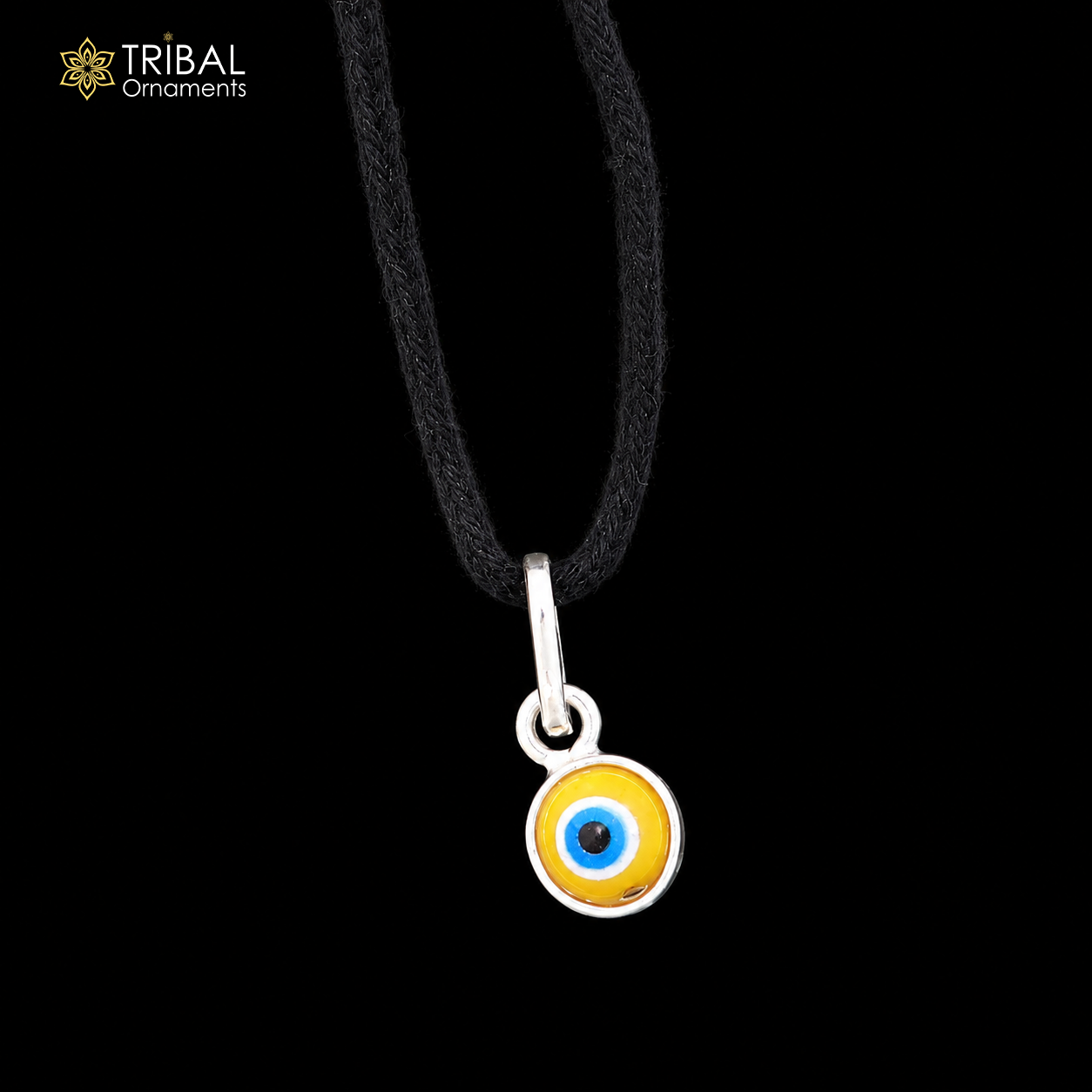 Sterling silver evil eye pendant for girls, children's protective jewelry by TRIBAL ORNAMENTS, featuring a detailed evil eye design.