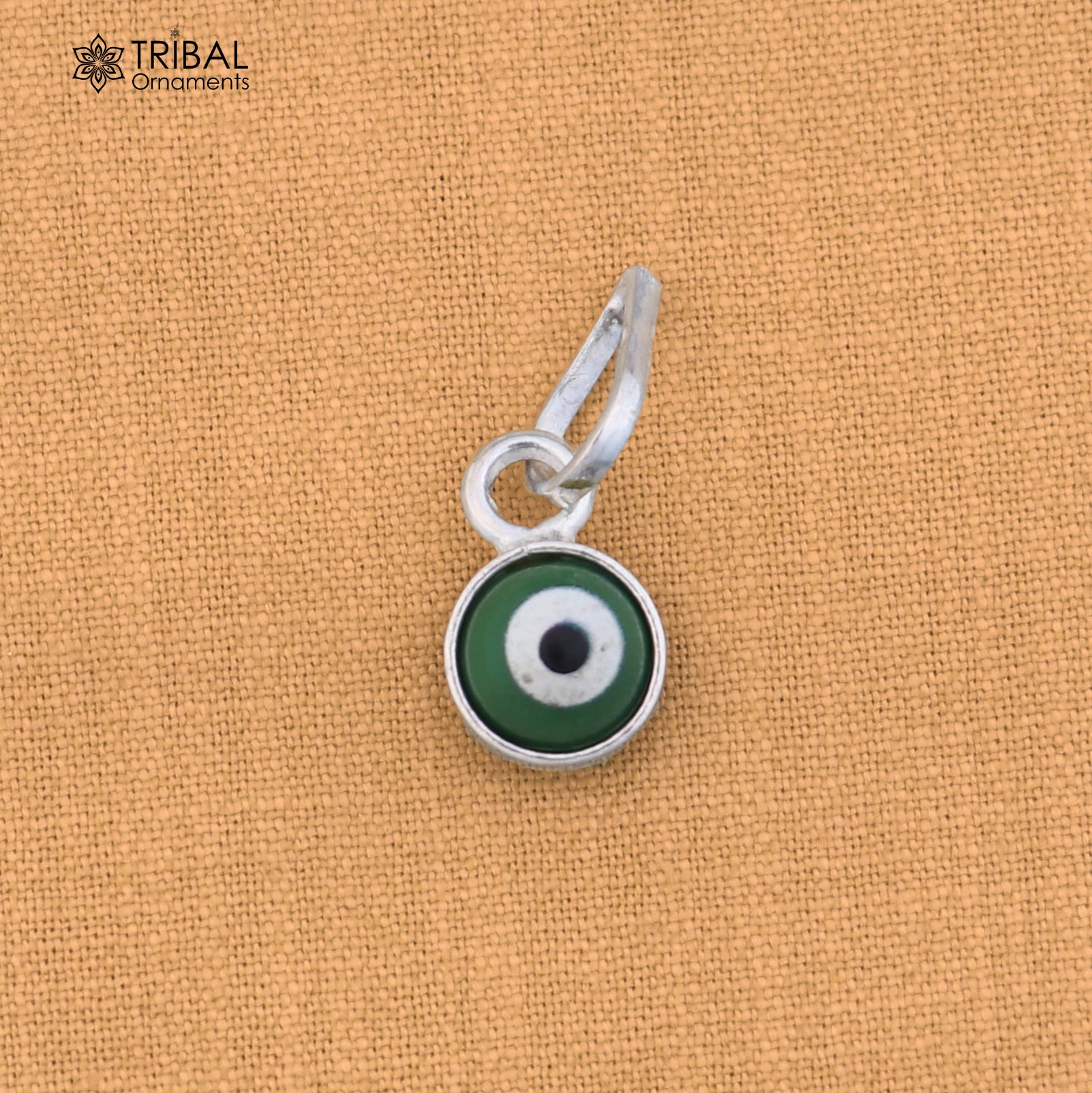 Sterling silver evil eye pendant for girls and kids, protective jewelry by TRIBAL ORNAMENTS, shown on a white background.