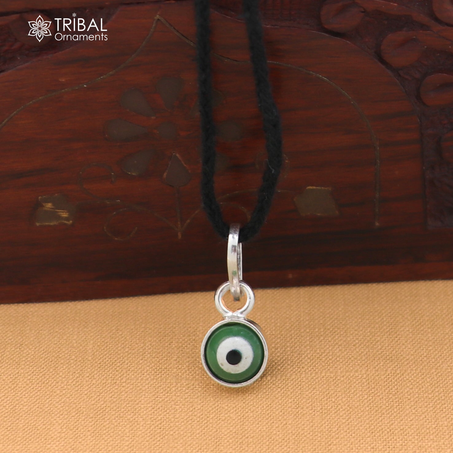 Sterling silver evil eye pendant for girls, protective jewelry by TRIBAL ORNAMENTS, featuring a blue evil eye design.