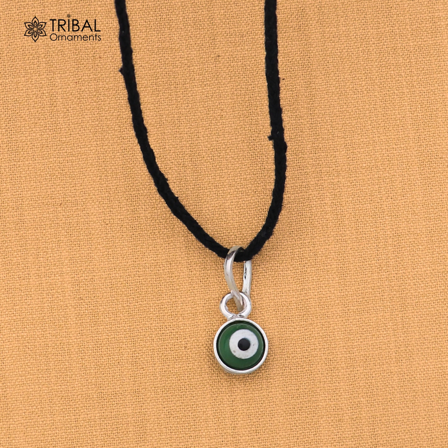 Sterling silver evil eye pendant for girls and kids, protective jewelry by TRIBAL ORNAMENTS, featuring a blue and silver design.